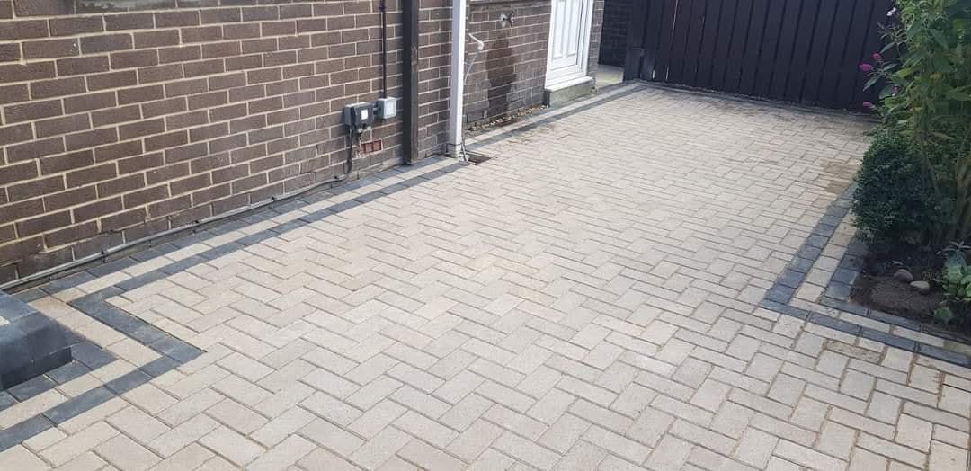 Buff herringbone block paving driveway with charcoal border completed by E.R.D Paving